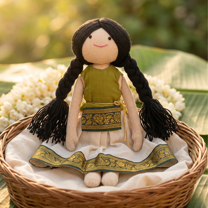 Textile doll with braided hair in a woven basket with flowers and leaves in the background