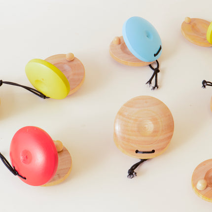 Colorful wooden toys resembling acorns on a white background