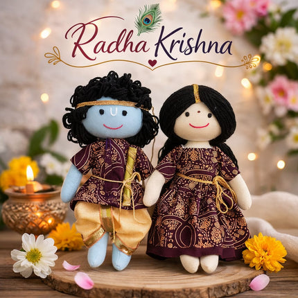 Two dolls in traditional attire with 'Radha Krishna' text and decorative elements.