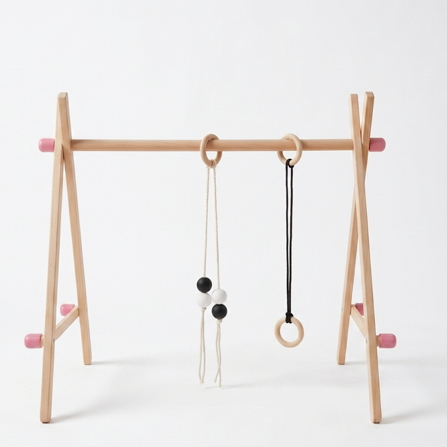 Wooden baby play gym with hanging toys on a white background