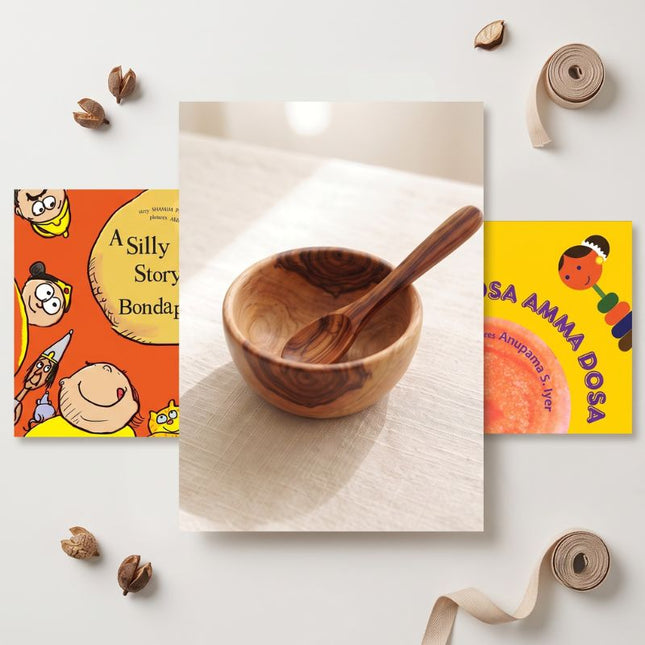 Wooden bowl and spoon with children's books on a white background
